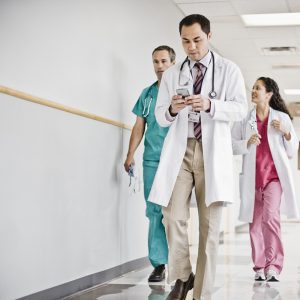 Doctor Using Cell Phone in Hallway