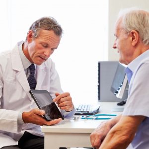 Senior Patient Having Consultation With Doctor In Office